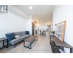 A living room with a grey couch and a wooden table.