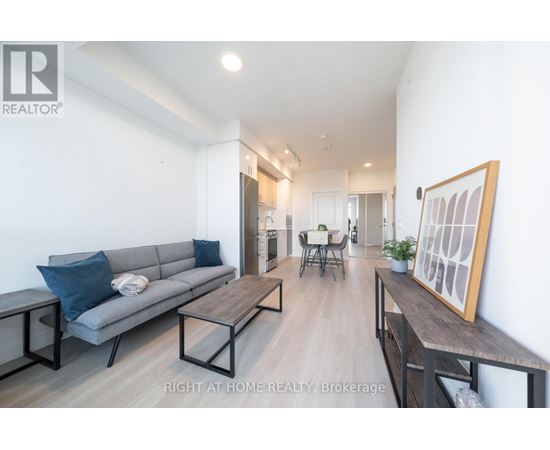 A living room with a grey couch and a wooden table.