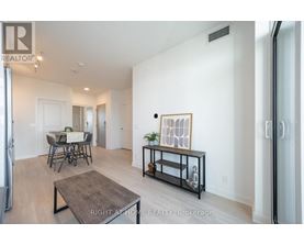 A living room with a dining table and chairs.