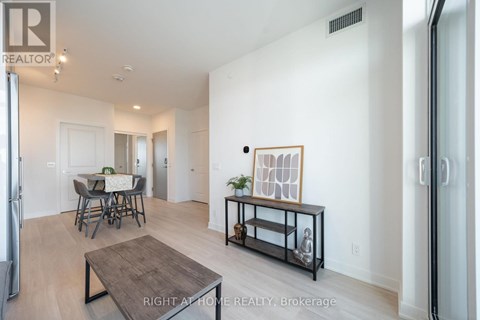 A living room with a dining table and chairs.