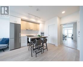 A modern kitchen with a dining table and chairs.