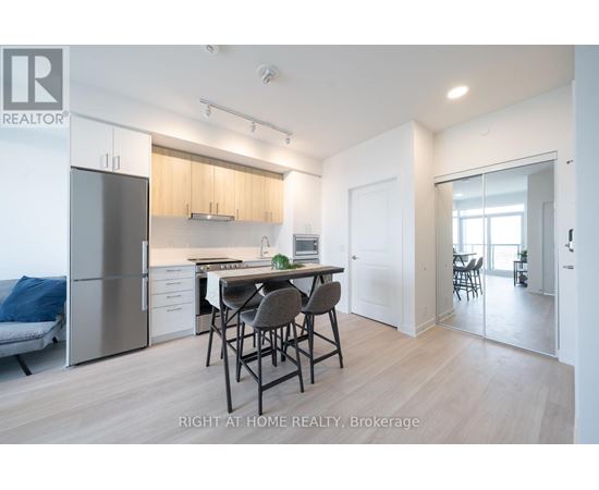 A modern kitchen with a dining table and chairs.