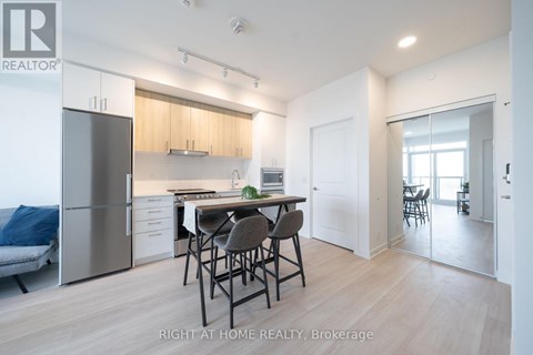 A modern kitchen with a dining table and chairs.