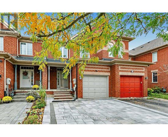 A brick house with a red garage door and a white door.
