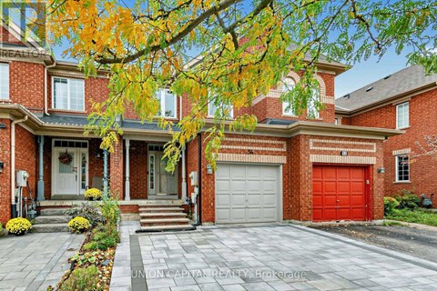 A brick house with a red garage door and a white door.