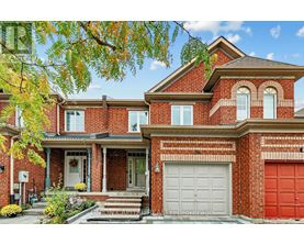 A red brick house with a white garage door.