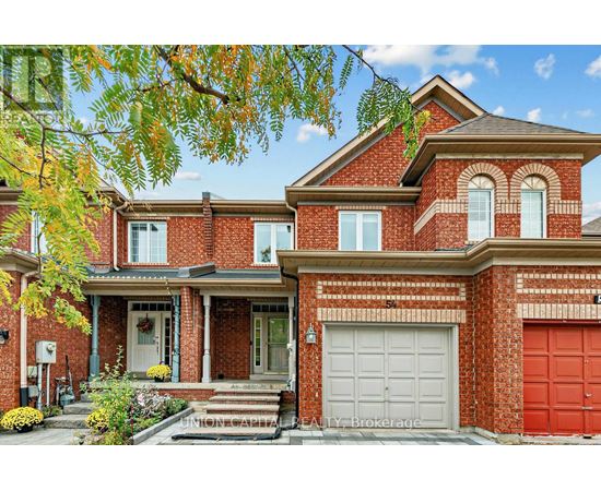A red brick house with a white garage door.