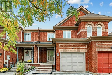 A red brick house with a white garage door.