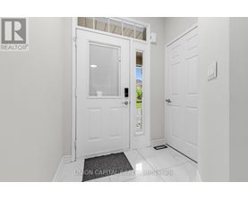 A white door with a glass window is in a hallway.