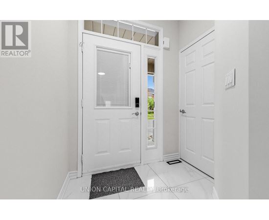 A white door with a glass window is in a hallway.