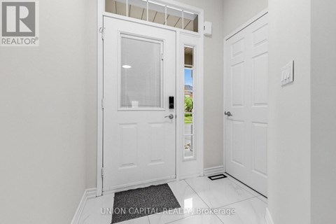 A white door with a glass window is in a hallway.
