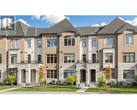A row of townhouses with a sign that says "HARVEY KALLES REAL ESTATE".