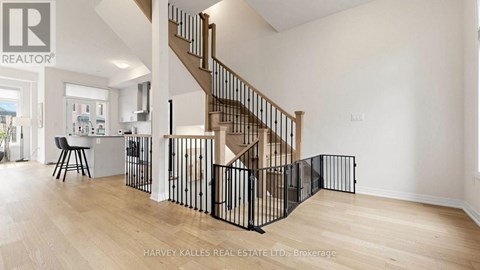 A spacious room with a staircase and a dining area.