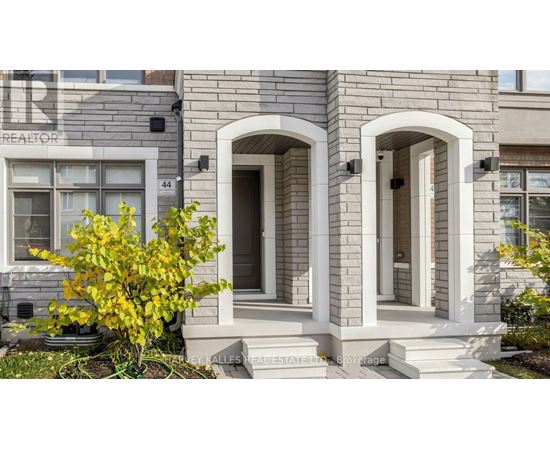 A house with a grey facade and a white door.