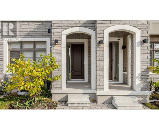 A house with a stone facade and a brown door.