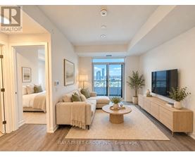 A well-lit, spacious living room with a television, couches, and a coffee table.