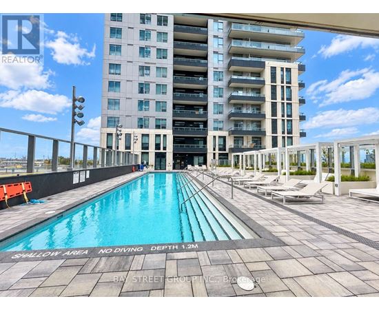 A swimming pool with a no diving sign in front of a building.