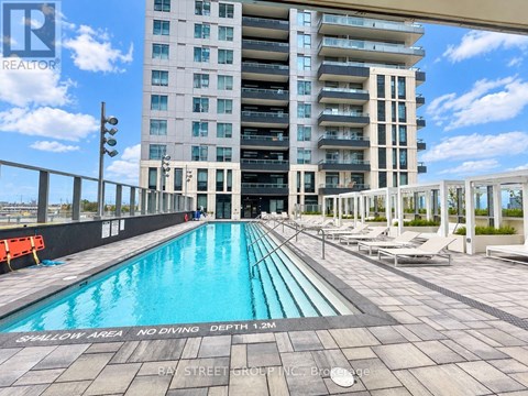 A swimming pool with a no diving sign in front of a building.