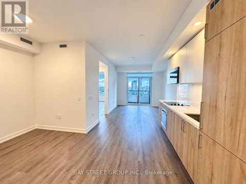 A spacious kitchen with wooden cabinets and a countertop.
