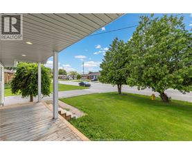 A realtor's sign is on the porch of a house.