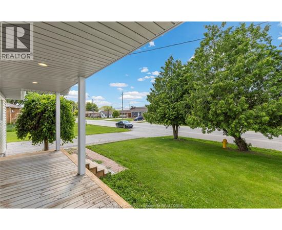A realtor's sign is on the porch of a house.