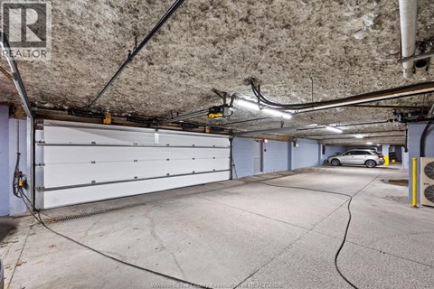 A spacious garage with a car parked inside.