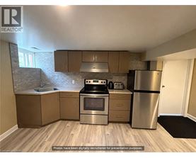 A kitchen with wooden floors and stainless steel appliances.