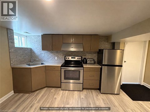 A kitchen with wooden floors and stainless steel appliances.