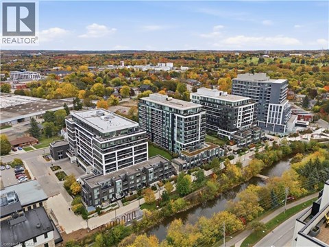 A realtor logo is visible on an aerial view of a riverfront property.