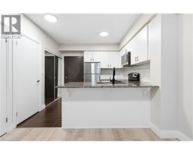 A modern kitchen with white cabinets and a central island.