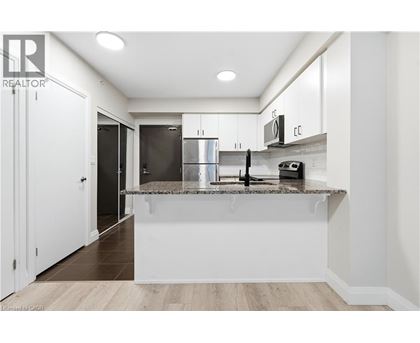 A modern kitchen with white cabinets and a central island.