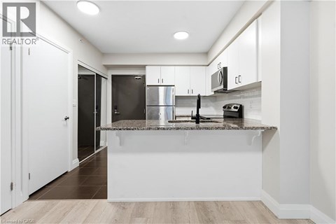 A modern kitchen with white cabinets and a central island.