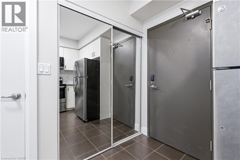 A white door is open to a kitchen.