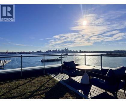A sunny day at the waterfront with a city skyline in the distance.
