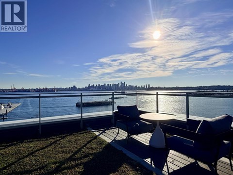 A sunny day at the waterfront with a city skyline in the distance.