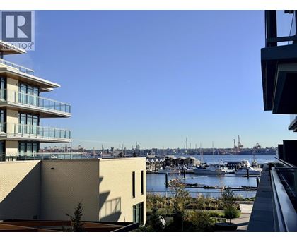 A view of a harbor with boats and buildings in the background.