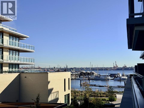 A view of a harbor with boats and buildings in the background.