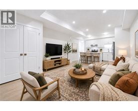 A living room with a wooden floor and furniture.