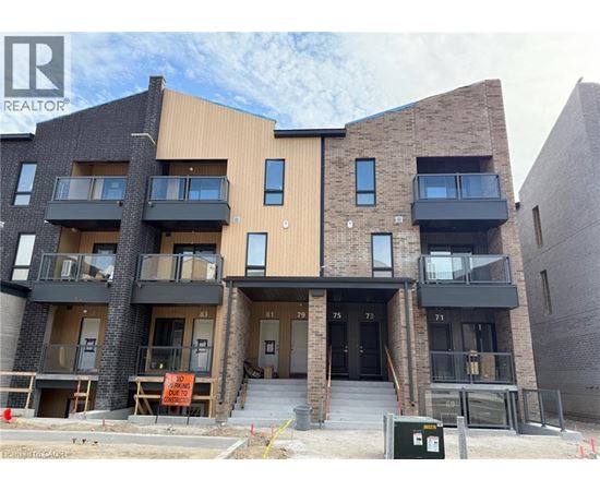 A modern apartment building with balconies and a sign that says "NO PARKING" in front of it.