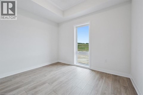 A room with a large window overlooking a field.