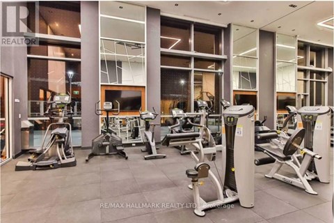 A gym with a variety of equipment including treadmills, weights, and exercise machines.