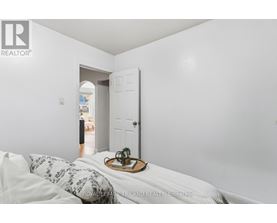 A bedroom with a bed and a tray with a plant on it.