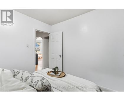 A bedroom with a bed and a tray with a plant on it.