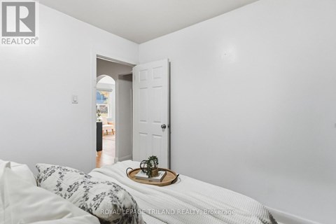 A bedroom with a bed and a tray with a plant on it.