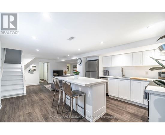 A well-lit kitchen with a dining table and chairs.