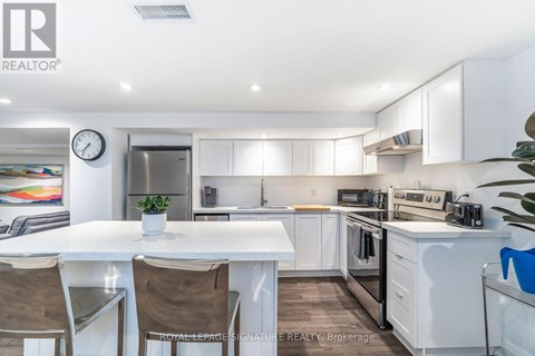 A white kitchen with a table and chairs.