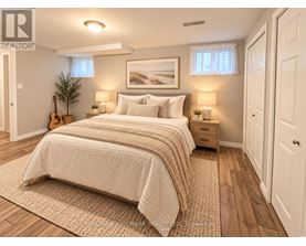 A bedroom with a large bed and a guitar on the floor.