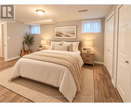 A bedroom with a large bed and a guitar on the floor.
