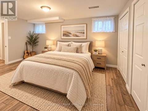 A bedroom with a large bed and a guitar on the floor.