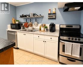 A kitchen with white cabinets and a black stove top oven.